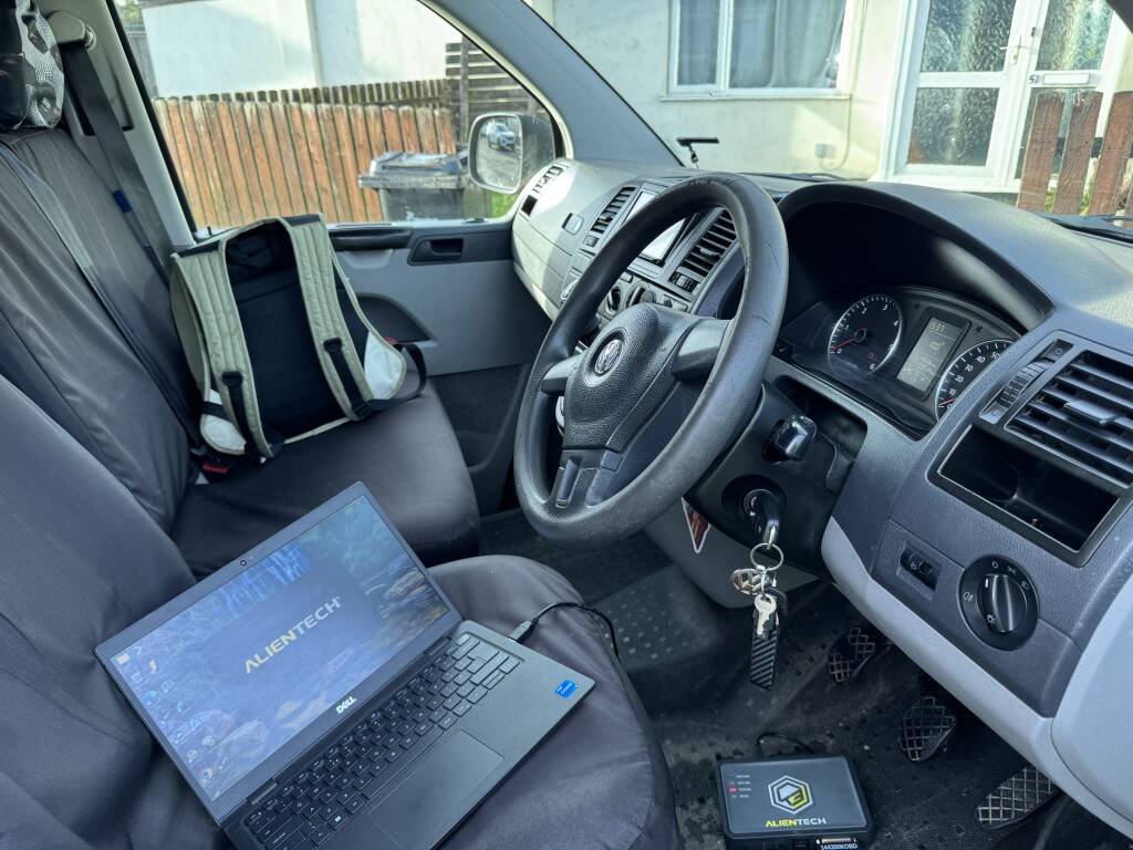 Alientech tuning equipment connected to VW T5 engine bay during map correction.