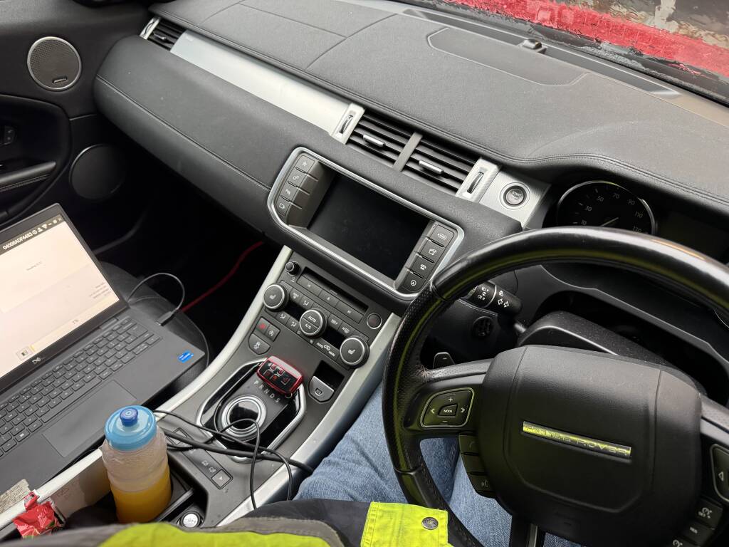 Laptop displaying ECU data during AdBlue delete on Range Rover Evoque.