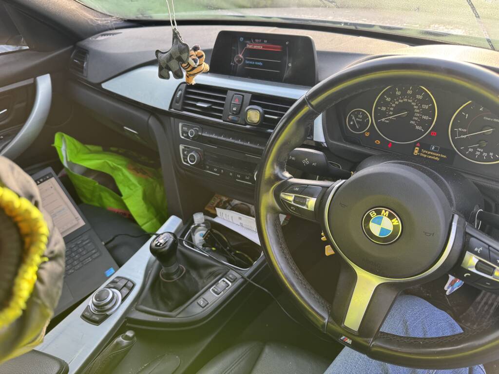 Laptop and tuning equipment during BMW 320d Stage 1 remap process.