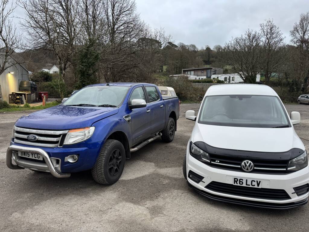 Kernowsport mobile VW Caddy parked beside Ford Ranger in Cornwall.